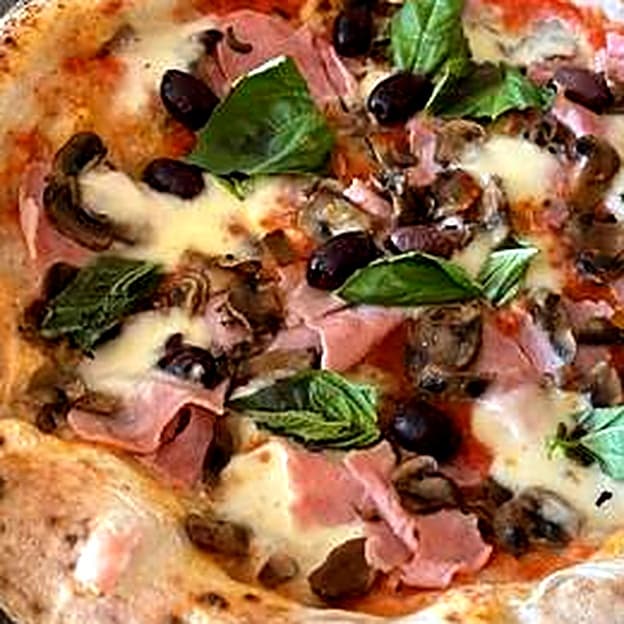 Prosciutto, mushroom and olive Neapolitan pizza