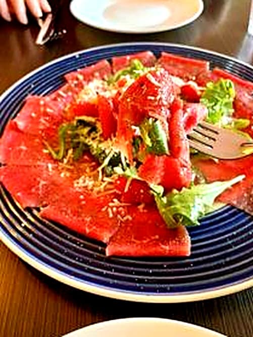 Beef carpaccio with parmesan and greens